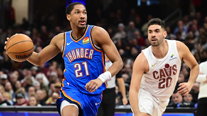 Jan 8, 2025; Cleveland, Ohio, USA; Oklahoma City Thunder guard Aaron Wiggins (21) drives to the basket against Cleveland Cavaliers forward Georges Niang (20) during the first half at Rocket Mortgage FieldHouse. Mandatory Credit: Ken Blaze-Imagn Images