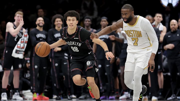 Jan 23, 2026; Brooklyn, New York, USA; Brooklyn Nets guard Nolan Traore (88) brings the ball up court against Boston Celtics guard Jaylen Brown (7) during double overtime at Barclays Center. Mandatory Credit: Brad Penner-Imagn Images