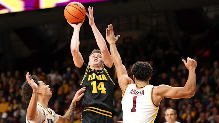 Jan 6, 2026; Minneapolis, Minnesota, USA; Iowa Hawkeyes guard Bennett Stirtz (14) shoots as Minnesota Golden Gophers guard Isaac Asuma (1) defends during the second half at Williams Arena. Mandatory Credit: Matt Krohn-Imagn Images Jan 6, 2026; Minneapolis, Minnesota, USA; Iowa Hawkeyes guard Bennett Stirtz (14) shoots as Minnesota Golden Gophers guard Isaac Asuma (1) defends during the second half at Williams Arena. Mandatory Credit: Matt Krohn-Imagn Images