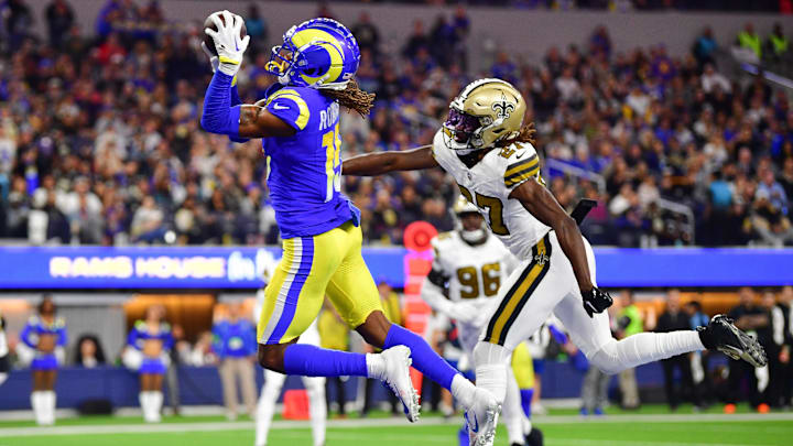 Dec 21, 2023; Inglewood, California, USA; Los Angeles Rams wide receiver Demarcus Robinson (15) catches a touchdown pass ahead of New Orleans Saints cornerback Isaac Yiadom (27) during the first half at SoFi Stadium. Mandatory Credit: Gary A. Vasquez-Imagn Images