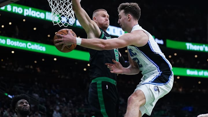 Apr 29, 2025; Boston, Massachusetts, USA; Orlando Magic forward Franz Wagner (22) passes the ball against Boston Celtics center Kristaps Porzingis (8) in the second quarter during game five of first round for the 2025 NBA Playoffs at TD Garden. Mandatory Credit: David Butler II-Imagn Images