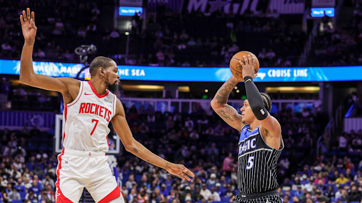Feb 26, 2026; Orlando, Florida, USA; Orlando Magic forward Paolo Banchero (5) passes in front of Houston Rockets forward Kevin Durant (7) during the first quarter at Kia Center. Mandatory Credit: Mike Watters-Imagn Images