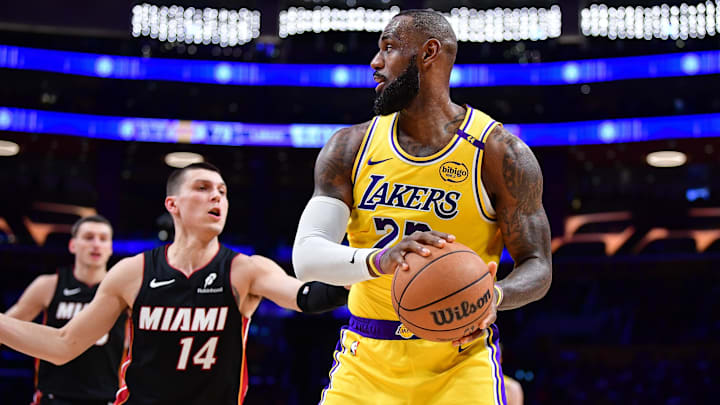 January 15, 2025; Los Angeles, California, USA; Los Angeles Lakers forward LeBron James (23) moves the ball against Miami Heat guard Tyler Herro (14) during the second half at Crypto.com Arena. Mandatory Credit: Gary A. Vasquez-Imagn Images