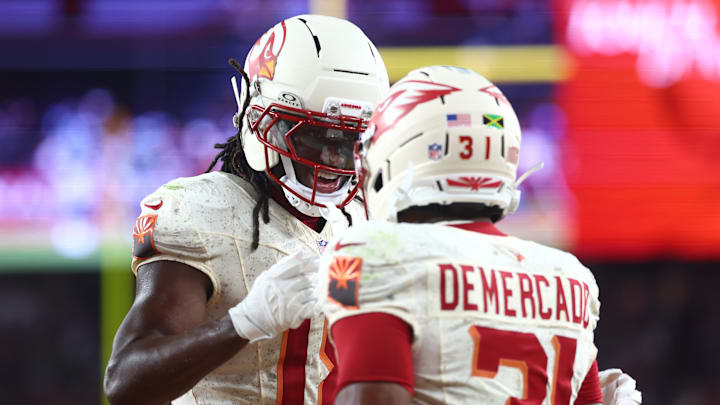Sep 25, 2025; Glendale, Arizona, USA;  Arizona Cardinals running back Emari Demercado (31) celebrates with wide receiver Marvin Harrison Jr. (18) after scoring a touchdown against the Seattle Seahawks in the fourth quarter at State Farm Stadium. Mandatory Credit: Mark J. Rebilas-Imagn Images