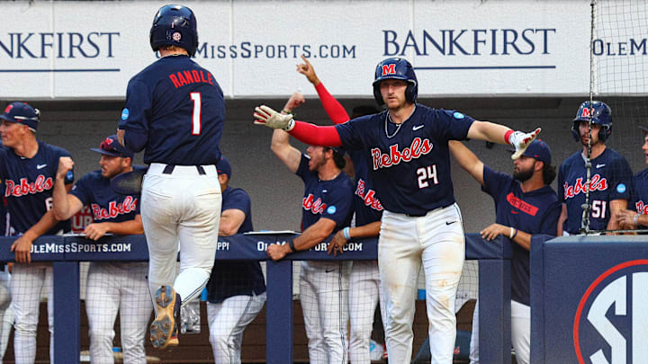Jun 2, 2025; Oxford, MS, USA; Mississippi Rebels catcher Austin Fawley (24) reacts with  shortstop Brayden Randle (1), after Randle scored during the seventh inning against the Murray State Racers. Mandatory Credit: Petre Thomas-Imagn Images