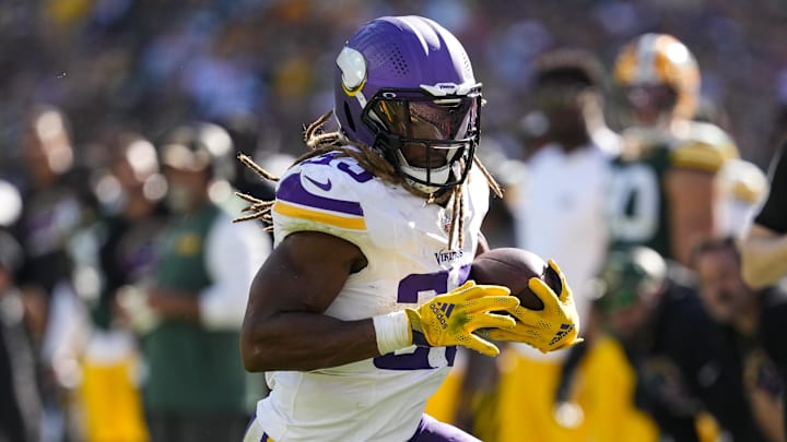 Sep 29, 2024; Green Bay, Wisconsin, USA; Minnesota Vikings running back Aaron Jones (33) rushes with the football during the fourth quarter against the Green Bay Packers at Lambeau Field. Sep 29, 2024; Green Bay, Wisconsin, USA; Minnesota Vikings running back Aaron Jones (33) rushes with the football during the fourth quarter against the Green Bay Packers at Lambeau Field.