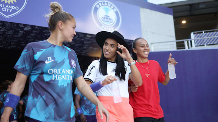 May 1, 2024; Orlando, Florida, USA; Orlando Pride defender Carrie Lawrence (12) walks with forward Marta before the game against the North Carolina Courage at Inter&Co Stadium. Mandatory Credit: Nathan Ray Seebeck-USA TODAY Sports