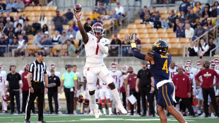Nov 11, 2023; Berkeley, California, USA; Washington State Cougars quarterback Cameron Ward (1) throws a touchdown pass against California Golden Bears defensive back Kaylin Moore (4) during the fourth quarter at California Memorial Stadium. Mandatory Credit: Darren Yamashita-USA TODAY Sports Nov 11, 2023; Berkeley, California, USA; Washington State Cougars quarterback Cameron Ward (1) throws a touchdown pass against California Golden Bears defensive back Kaylin Moore (4) during the fourth quarter at California Memorial Stadium. Mandatory Credit: Darren Yamashita-USA TODAY Sports