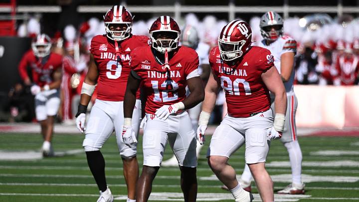 Oct 17, 2026; Bloomington, Indiana, USA; Indiana Hoosiers defensive line Tobi Osunsanmi (12) celebrates with teammates after sacking Ohio State Buckeyes quarterback Julian Sayin (10) during the first half at Merchants Bank Field at Memorial Stadium. Mandatory Credit: Robert Goddin-Imagn Images Oct 17, 2026; Bloomington, Indiana, USA; Indiana Hoosiers defensive line Tobi Osunsanmi (12) celebrates with teammates after sacking Ohio State Buckeyes quarterback Julian Sayin (10) during the first half at Merchants Bank Field at Memorial Stadium. Mandatory Credit: Robert Goddin-Imagn Images