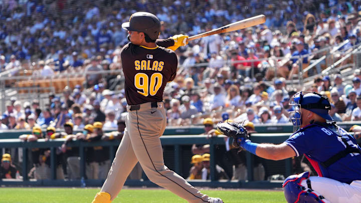 Feb 23, 2025; Phoenix, Arizona, USA; San Diego Padres catcher Ethan Salas (90) hits a double against the Los Angeles Dodgers during the second inning at Camelback Ranch-Glendale. Mandatory Credit: Joe Camporeale-Imagn Images