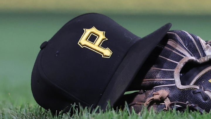 Sep 16, 2025; Pittsburgh, Pennsylvania, USA; A hat and glove belonging to Pittsburgh Pirates third baseman Jared Triolo (not pictured) on the field against the Chicago Cubs during the sixth inning at PNC Park. Mandatory Credit: Charles LeClaire-Imagn Images Sep 16, 2025; Pittsburgh, Pennsylvania, USA; A hat and glove belonging to Pittsburgh Pirates third baseman Jared Triolo (not pictured) on the field against the Chicago Cubs during the sixth inning at PNC Park. Mandatory Credit: Charles LeClaire-Imagn Images