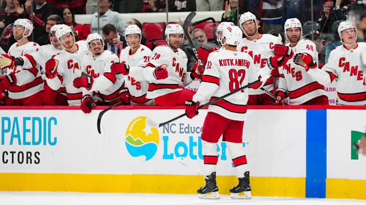 Oct 4, 2024; Raleigh, North Carolina, USA;  Carolina Hurricanes center Jesperi Kotkaniemi (82) celebrates his goal against the Tampa Bay Lightning during the second period at PNC Arena. Mandatory Credit: James Guillory-Imagn Images