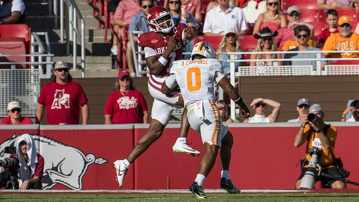 Oct 10, 2026; Fayetteville, Arkansas, USA;  Arkansas Razorbacks quarterback KJ Jackson (7) is pressured by Tennessee Volunteers linebacker Amare Campbell (0) during the second quarter at Donald W. Reynolds Razorback Stadium.  Mandatory Credit: Brett Rojo-Imagn Images