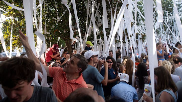 Fans toss toilet paper during the filming of the ESPN show Eli’s Places at Toomer’s Corner in Auburn, Ala. on Tuesday, July 8, 2025.