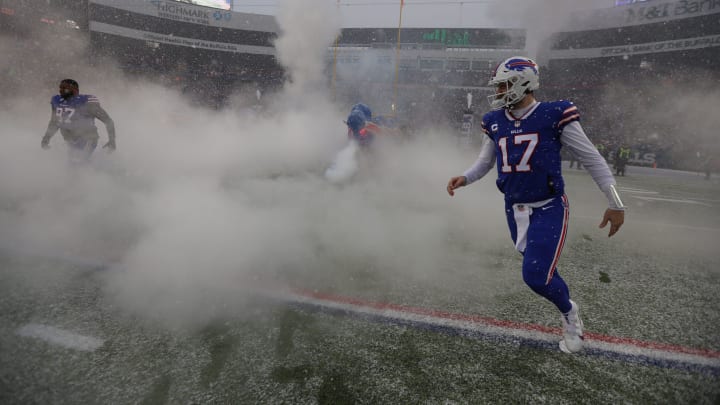 Bills quarterback Josh Allen runs around the smoke to stand in line to greet his teammates as they Bills quarterback Josh Allen runs around the smoke to stand in line to greet his teammates as they