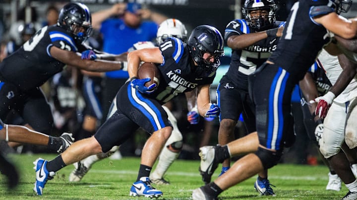 Montgomery Catholic's Giovanni Hayner (11) follows his offensive line on his way to gaining a chunk of yardage in the Knights' 63-3 blowout of Charles Henderson, Friday night. Catholic has now won 38 straight regular season games.