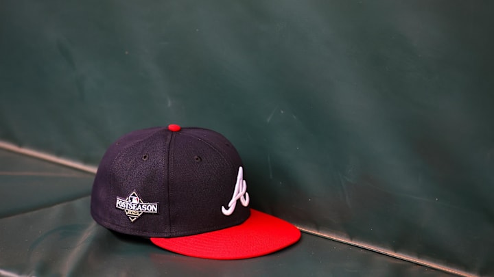 Oct 6, 2023; Atlanta, GA, USA; A detailed view of an Atlanta Braves postseason hat on the bench during a workout before the NLDS against the Philadelphia Phillies at Truist Park. Mandatory Credit: Brett Davis-Imagn Images