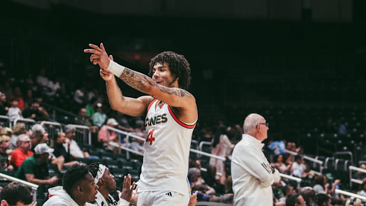Freshman Isaiah Johnson Arigu celebrating a three-pointer on the sideline