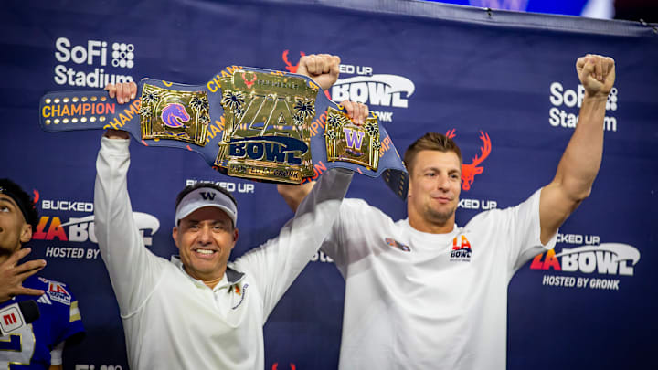 Jedd Fisch and Rob Gronkowski hold up the LA Bowl trophy, which resembles a belt. 