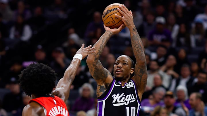 Jan 16, 2025; Sacramento, California, USA; Sacramento Kings forward DeMar DeRozan (10) shoots the ball against Houston Rockets forward Amen Thompson (1) during the second quarter at Golden 1 Center. Mandatory Credit: Sergio Estrada-Imagn Images