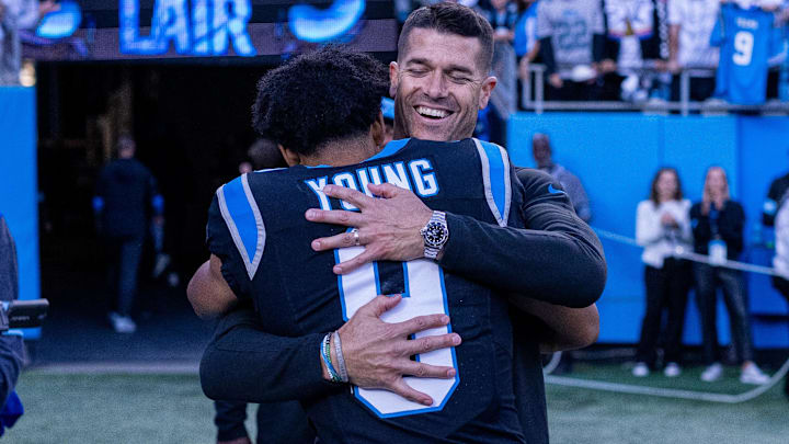 Carolina Panthers head coach Dave Canales hugs quarterback Bryce Young (9) after getting the win against the New Orleans Saints at Bank of America Stadium.