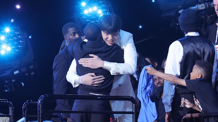 Jun 25, 2025; Brooklyn, NY, USA;  Yang Hansen walks to the stage after being selected as the 16th pick by the Memphis Grizzlies in the first round of the 2025 NBA Draft at Barclays Center. Mandatory Credit: Brad Penner-Imagn Images