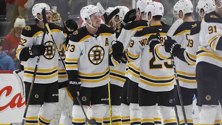 Nov 23, 2024; Detroit, Michigan, USA; The Boston Bruins celebrate their win over the Detroit Red Wing at Little Caesars Arena. Mandatory Credit: Brian Bradshaw Sevald-Imagn Images