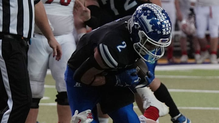 MMCRU's wide receiver Gage Johnson (2) gets tackle Saint Ansgar linebacker Korben Michels (2) after making a first down during the first quarter in the class-A state football championship on Nov. 20, 2025, at UNI Dome in Cedar Falls, Iowa.