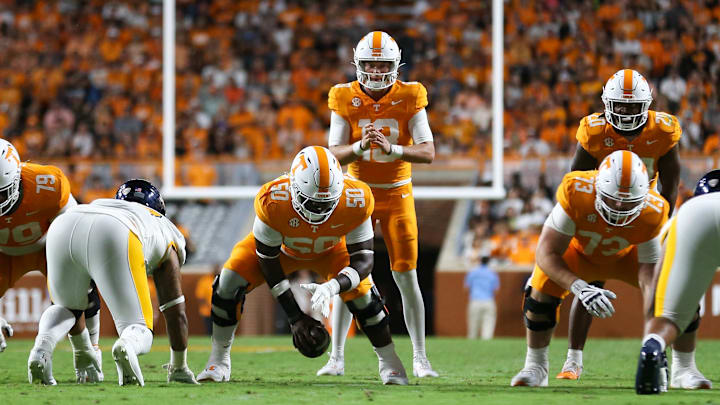 Sep 14, 2024; Knoxville, Tennessee, USA; Tennessee Volunteers quarterback Gaston Moore (13) receives a snap from offensive lineman William Satterwhite (50) during the game against the Kent State Golden Flashes at Neyland Stadium. Mandatory Credit: Randy Sartin-Imagn Images