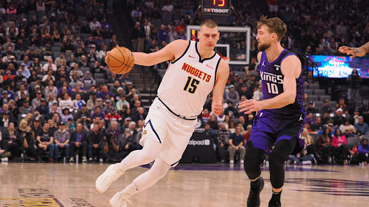 Feb 9, 2024; Sacramento, California, USA; Denver Nuggets center Nikola Jokic (15) drives in against Sacramento Kings center Domantas Sabonis (10) during the first quarter at Golden 1 Center. Mandatory Credit: Kelley L Cox-Imagn Images