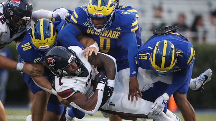 Delaware's Nick Karika (98) Q'yaeir Price (0) and K.T. Seay tackle Penn running back Malachi Hosley in the second quarter at Delaware Stadium, Saturday, Sept. 21, 2024.