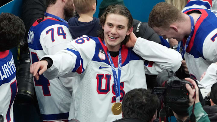 Feb 22, 2026; Milan, Italy; Jack Hughes of the United States celebrates after winning the men's ice hockey gold medal game during the Milano Cortina 2026 Olympic Winter Games at Milano Santagiulia Ice Hockey Arena. Mandatory Credit: James Lang-Imagn Images