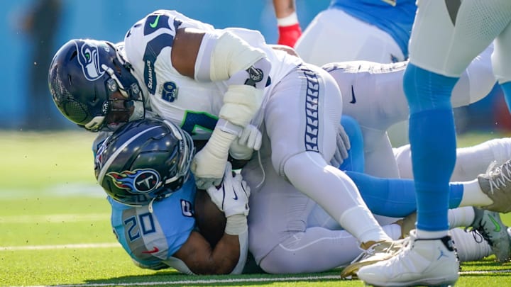 Seattle Seahawks linebacker Uchenna Nwosu (7) tackles Tennessee Titans running back Tony Pollard (20) during the first quarter at Nissan Stadium in Nashville, Tenn., Sunday, Nov. 23, 2025.