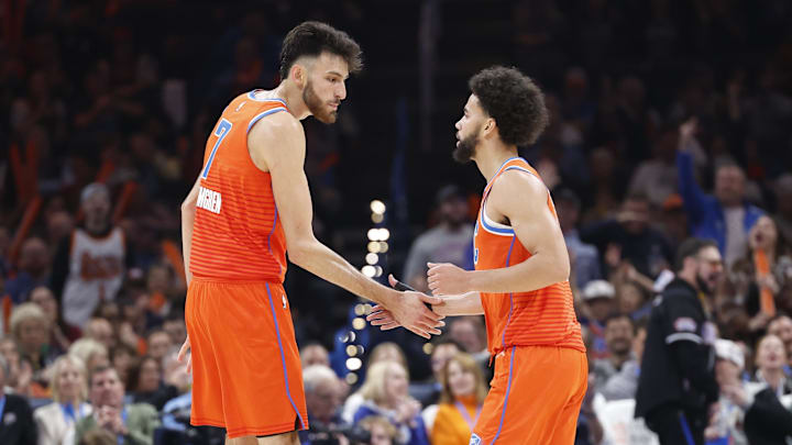 Nov 8, 2024; Oklahoma City, Oklahoma, USA; Oklahoma City Thunder forward Chet Holmgren (7) and guard Ajay Mitchell (25) high five after a play against the Houston Rockets during the second quarter at Paycom Center.