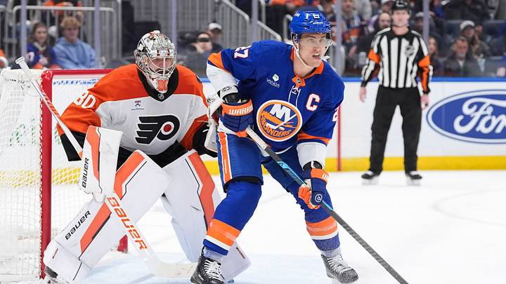 Apr 3, 2026; Elmont, New York, USA; Philadelphia Flyers goaltender Dan Vladar (80) and New York Islanders forward Anders Lee (27) wait for the puck during the second period at UBS Arena. 