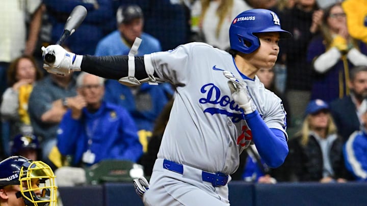 Oct 14, 2025; Milwaukee, Wisconsin, USA; Los Angeles Dodgers designated hitter Shohei Ohtani (17) hits an RBI single against the Milwaukee Brewers in the seventh inning during game two of the NLCS round for the 2025 MLB playoffs at American Family Field. Mandatory Credit: Benny Sieu-Imagn Images Oct 14, 2025; Milwaukee, Wisconsin, USA; Los Angeles Dodgers designated hitter Shohei Ohtani (17) hits an RBI single against the Milwaukee Brewers in the seventh inning during game two of the NLCS round for the 2025 MLB playoffs at American Family Field. Mandatory Credit: Benny Sieu-Imagn Images