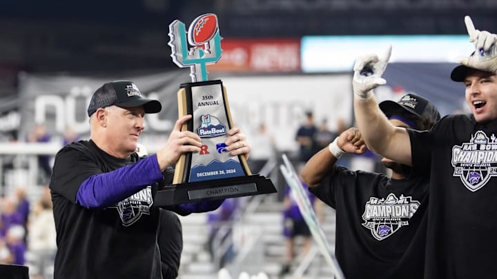 Dec 26, 2024; Phoenix, AZ, USA; Kansas State Wildcats head coach Chris Klieman celebrates with the trophy after defeating the Rutgers Scarlet Knights during the Rate Bowl at Chase Field. Mandatory Credit: Mark J. Rebilas-Imagn Images