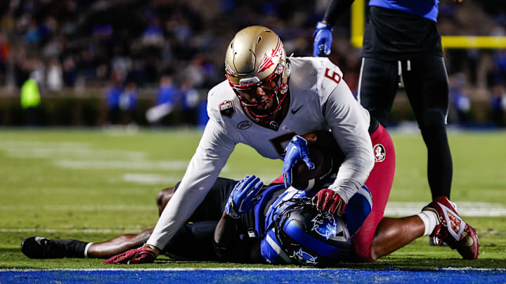 Oct 18, 2024; Durham, North Carolina, USA; Duke Blue Devils quarterback Maalik Murphy (6) attempts to run the ball to the end zone but is tacked by Florida State Seminoles defensive lineman Darrell Jackson Jr. (6) during the first half of the game at Wallace Wade Stadium. Mandatory Credit: Jaylynn Nash-Imagn Images