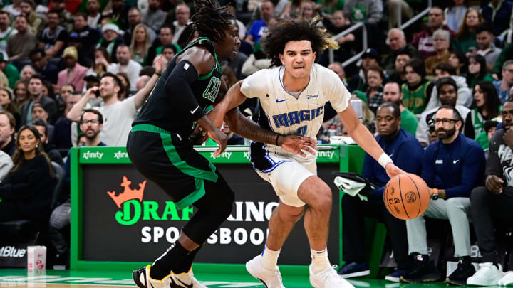 Orlando Magic guard Anthony Black (0) drives the ball against Boston Celtics guard Jrue Holiday (4) during the first half at TD Garden. 