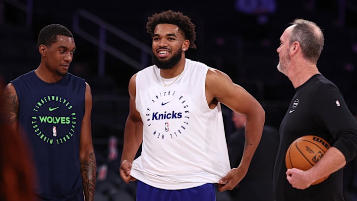 Oct 13, 2024; New York, New York, USA; New York Knicks center Karl-Anthony Towns (32), center, walks with Minnesota Timberwolves forward Jaden McDaniels (3), left, and assistant coach Kevin Hanson before the game at Madison Square Garden. Mandatory Credit: Vincent Carchietta-Imagn Images