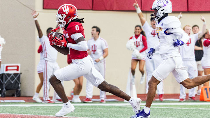 Indiana Hoosiers wide receiver Andison Coby (0) runs the ball after a catch for a touchdown while Western Illinois Leathernecks defensive back Braylen Brooks (7) defends in the first quarter at Memorial Stadium. Indiana Hoosiers wide receiver Andison Coby (0) runs the ball after a catch for a touchdown while Western Illinois Leathernecks defensive back Braylen Brooks (7) defends in the first quarter at Memorial Stadium.