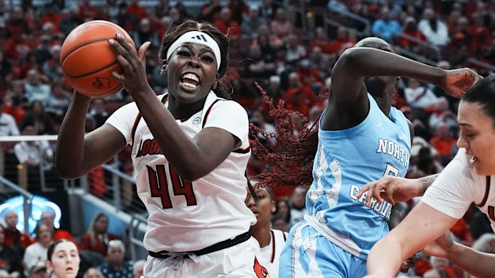 Louisville's Olivia Cochran (44) pulls down a rebound against North Carolina' s Maria Gakdeng (5) during their game at the KFC Yum! Center in Louisville, Ky. on Feb. 23, 2025.