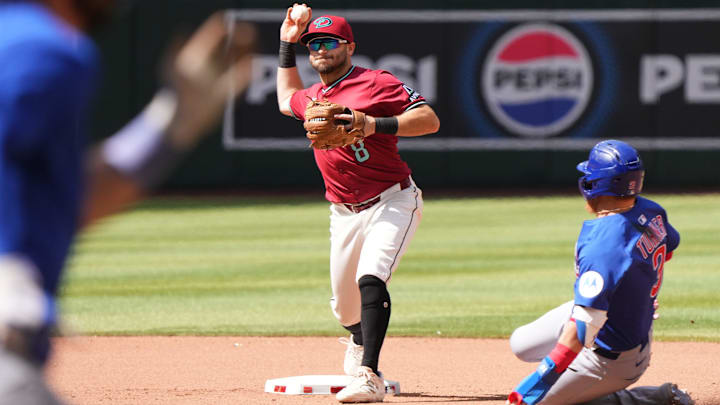 Arizona Diamondbacks infielder Garrett Hampson (8) gets the force out on Chicago Cubs Justin Turner (3) and throws for the double play on Dansby Swanson (7) at Chase Field in Phoenix on Sunday, March 30, 2025. Arizona Diamondbacks infielder Garrett Hampson (8) gets the force out on Chicago Cubs Justin Turner (3) and throws for the double play on Dansby Swanson (7) at Chase Field in Phoenix on Sunday, March 30, 2025.