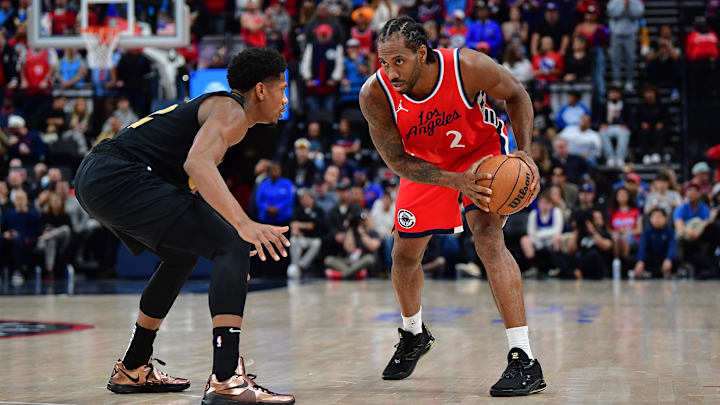 Mar 18, 2025; Inglewood, California, USA; Los Angeles Clippers forward Kawhi Leonard (2) controls the ball against Cleveland Cavaliers forward De'Andre Hunter (12) during the second half at Intuit Dome. Mandatory Credit: Gary A. Vasquez-Imagn Images Mar 18, 2025; Inglewood, California, USA; Los Angeles Clippers forward Kawhi Leonard (2) controls the ball against Cleveland Cavaliers forward De'Andre Hunter (12) during the second half at Intuit Dome. Mandatory Credit: Gary A. Vasquez-Imagn Images