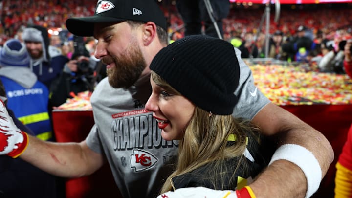 Recording artist Taylor Swift  and Kansas City Chiefs tight end Travis Kelce (87) react after the AFC Championship game against the Buffalo Bills at GEHA Field at Arrowhead Stadium.