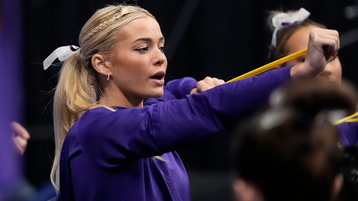 LSU gymnast Livvy Dunne stretches with teammates before Session 2 of the SEC Gymnastics Tournament at Legacy Arena in Birmingham, Alabama.