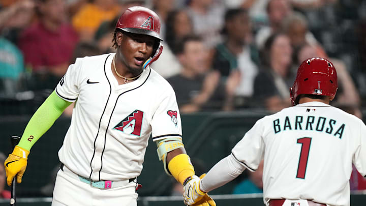 Aug 4, 2025; Phoenix, Ariz, U.S.; Arizona Diamondbacks Geraldo Perdomo (2) congratulates teammate Jorge Barrosa (1) after scoring a run against the San Diego Padres at Chase Field on Aug. 4, 2025.