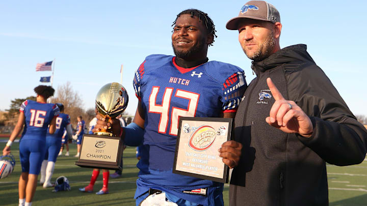 Hutchinson's Nadame Tucker holds his Defensive Most Valuable Player award and championship trophy. Hutchinson's Nadame Tucker holds his Defensive Most Valuable Player award and championship trophy.