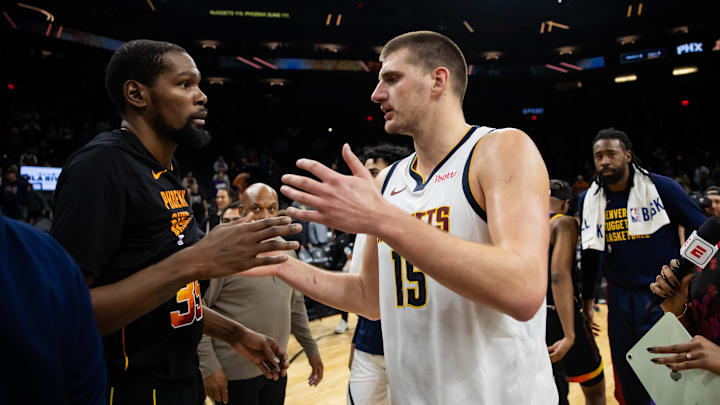 Denver Nuggets center Nikola Jokic (right) greets Phoenix Suns star Kevin Durant.