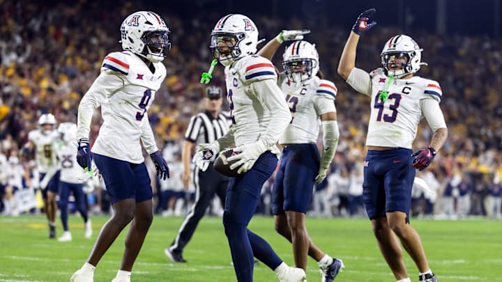 Nov 28, 2025; Tempe, Arizona, USA; Arizona Wildcats defensive back Treydan Stukes (2) celebrates with defensive back Ayden Garnes (9) after an interception against Arizona State Sun Devils in the second half during the 99th Territorial Cup at Mountain America Stadium. Mandatory Credit: Mark J. Rebilas-Imagn Images